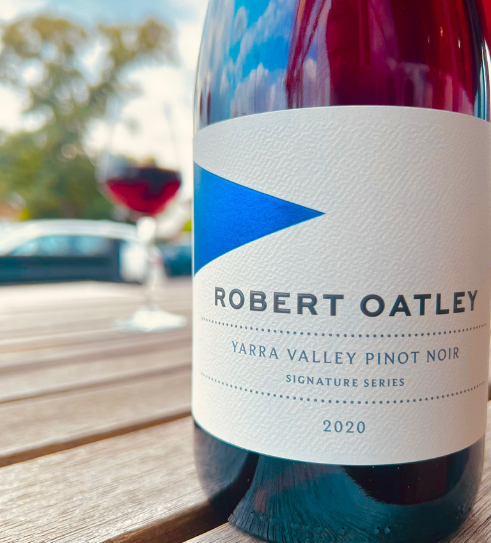 A close up in the foreground of Robert Oatley's Pinot Noir with a poured glass in the background.